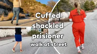 Cuffed shackled prisioner walk at street