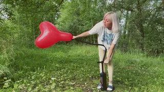 Alla destroys three balloons with a hand pump