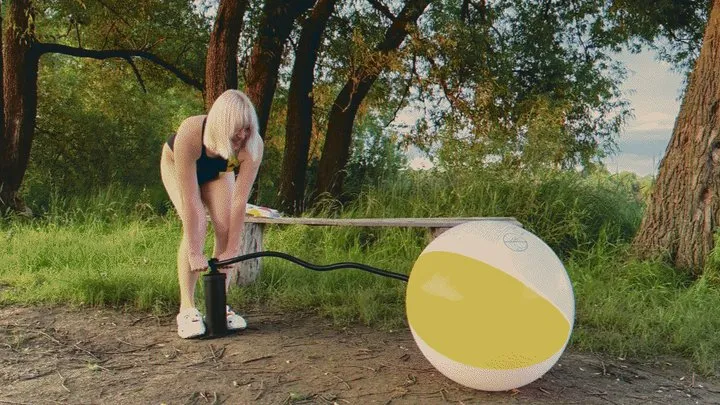 Alla pumps a new beach ball with a hand pump and it bursts loudly