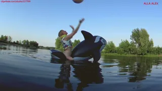 Alla is riding hot on a big inflatable whale on the lake and playing with a beach ball!!!