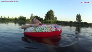 Alla floats on an inflatable ring on the lake and wears an inflatable vest for safety!!!