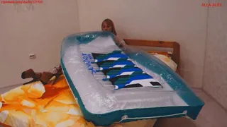 Alla inflates a large rare transparent air mattress with her mouth