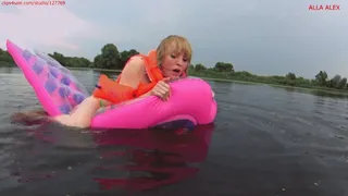 Alla rides hotly on a transparent pink squeaky air mattress on the lakes and wears an inflatable vest and inflatable armbands on her arms and pop the nail of the air mattress during the pleasures!!!
