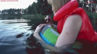 Alla swims on an inflatable ring in the lake and POPs it with a stick and wears a red inflatable vest on her naked body!!!