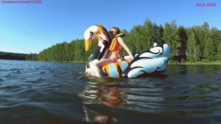 Alla wears an inflatable swimming vest and swims on the lake and climbs on an inflatable swan!!!