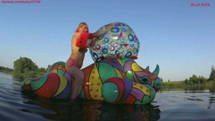 Alla rides on an inflatable rhinoceros and plays with a large beach ball and deflates the beach ball!!!