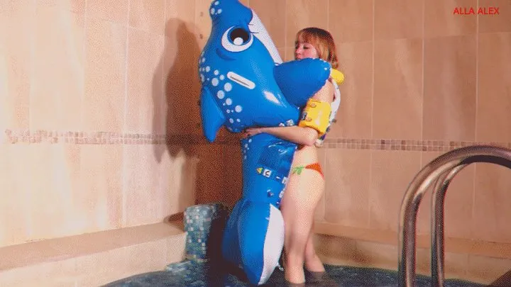 Alla blows off the blue inflatable whale in the pool and wears an inflatable vest!!!