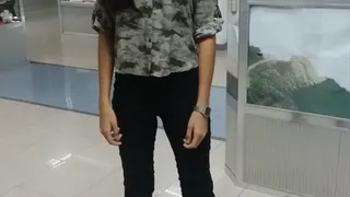 Venezuelian girl learning how to spit in a mall