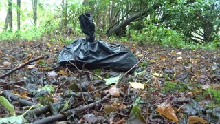 Litter, crushed plastic model train houses in forest wearing Timberland Boots