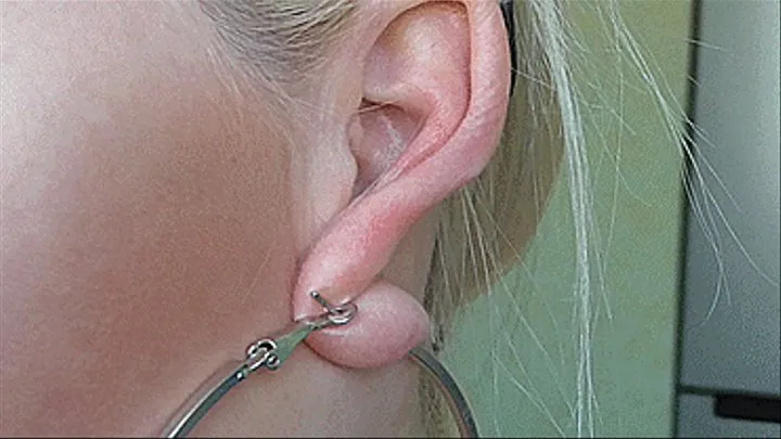 Sexy lobes of large ears are stretched by a blonde!