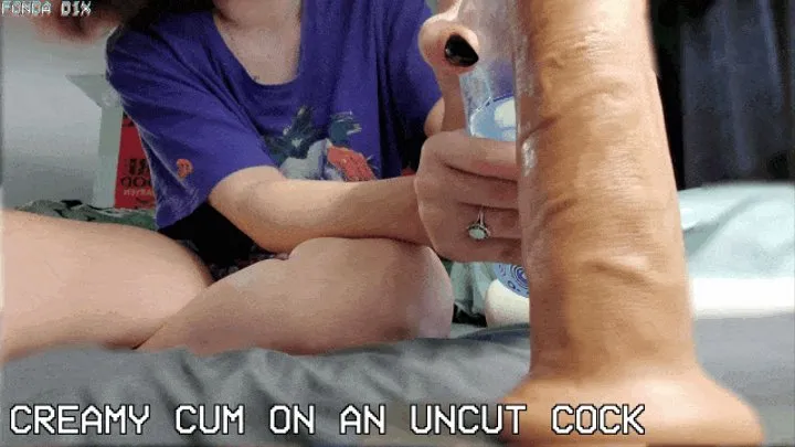 Creamy cum on an uncut cock