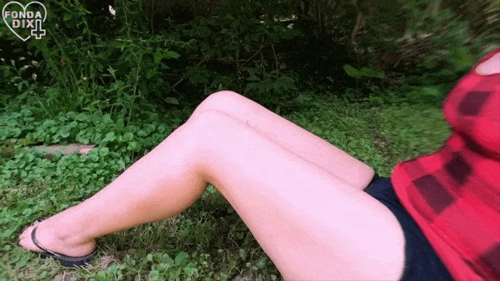 Sitting in the shade, flexing her calves