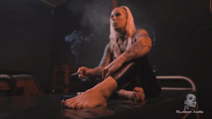 Smoking barefoot on pvc bed