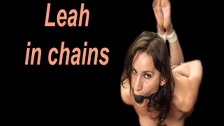 Leah in chains wriggling on the table