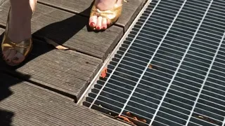 Golden vintage slingback sandals stuck in a grate Struggling to get unstuck but it's impossible to move!