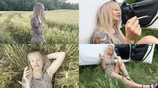 Blonde relaxes in nature and smokes 2 cigarettes