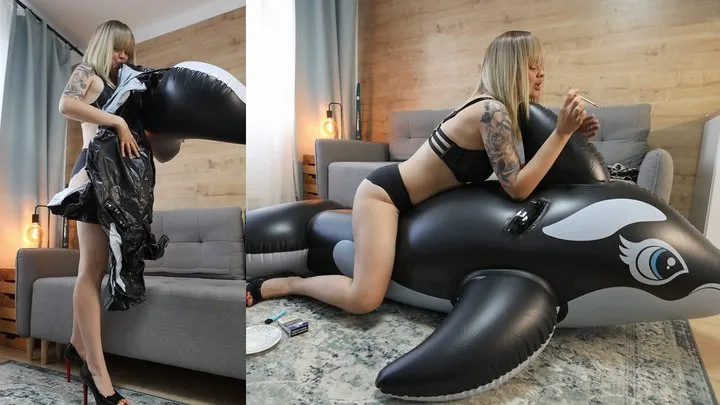 Anastasia blowing inflatable whale, then smoking on it and teasing