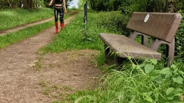 Hot Girl with red Hunter and Latexleggings at the Forrest with Kneeorthesis