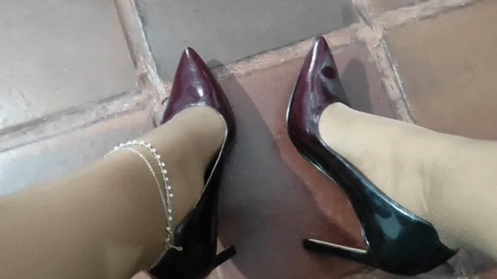 Stiletto heels dangle from feet with pantyhose stockings (2)