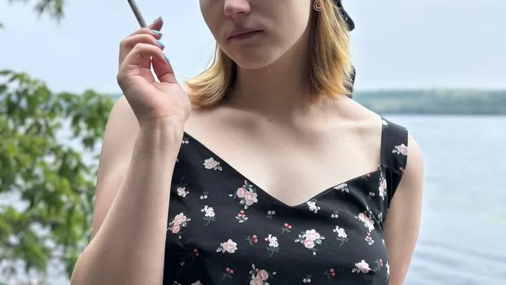 Lonely girl from the village smokes a cigarette and fucks herself with a long black dildo