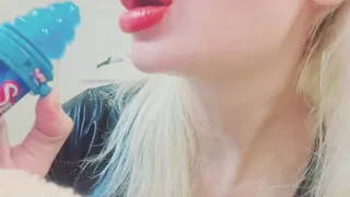 Sucking and licking blue lollipop