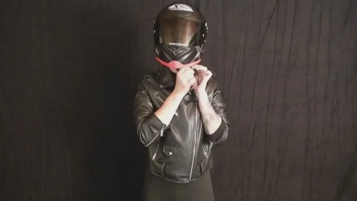 Sophia tries on the right size motorcycle helmet