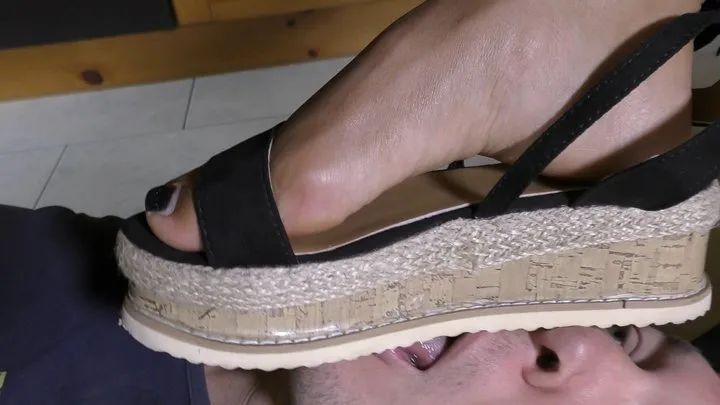 Sandals and foot worship under table