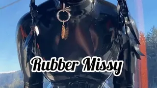 Rubber Snowboard ride Rubbermissy in shiny latex catsuit goes on the slopes with catsuit, latex mask, corset