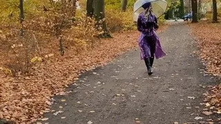 Rainy Park stroll Rubbermissy walks in public in purple rubber catsuit with shiny transparent PVC raincoat, latex mask, wellies