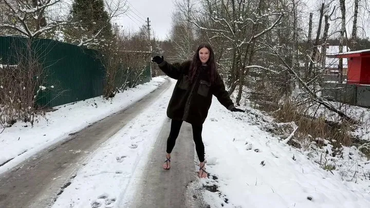 Girl on high heels sandals on ice