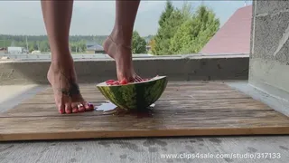 Beautiful feet ruthlessly crushed a watermelon