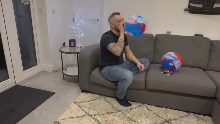 Hot guy blowing up balloons