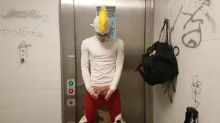 Clown jerking off and putting on condom in public restroom