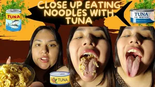 Close up eating noodles with tuna