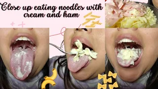 Close up eating noodles with cream and ham